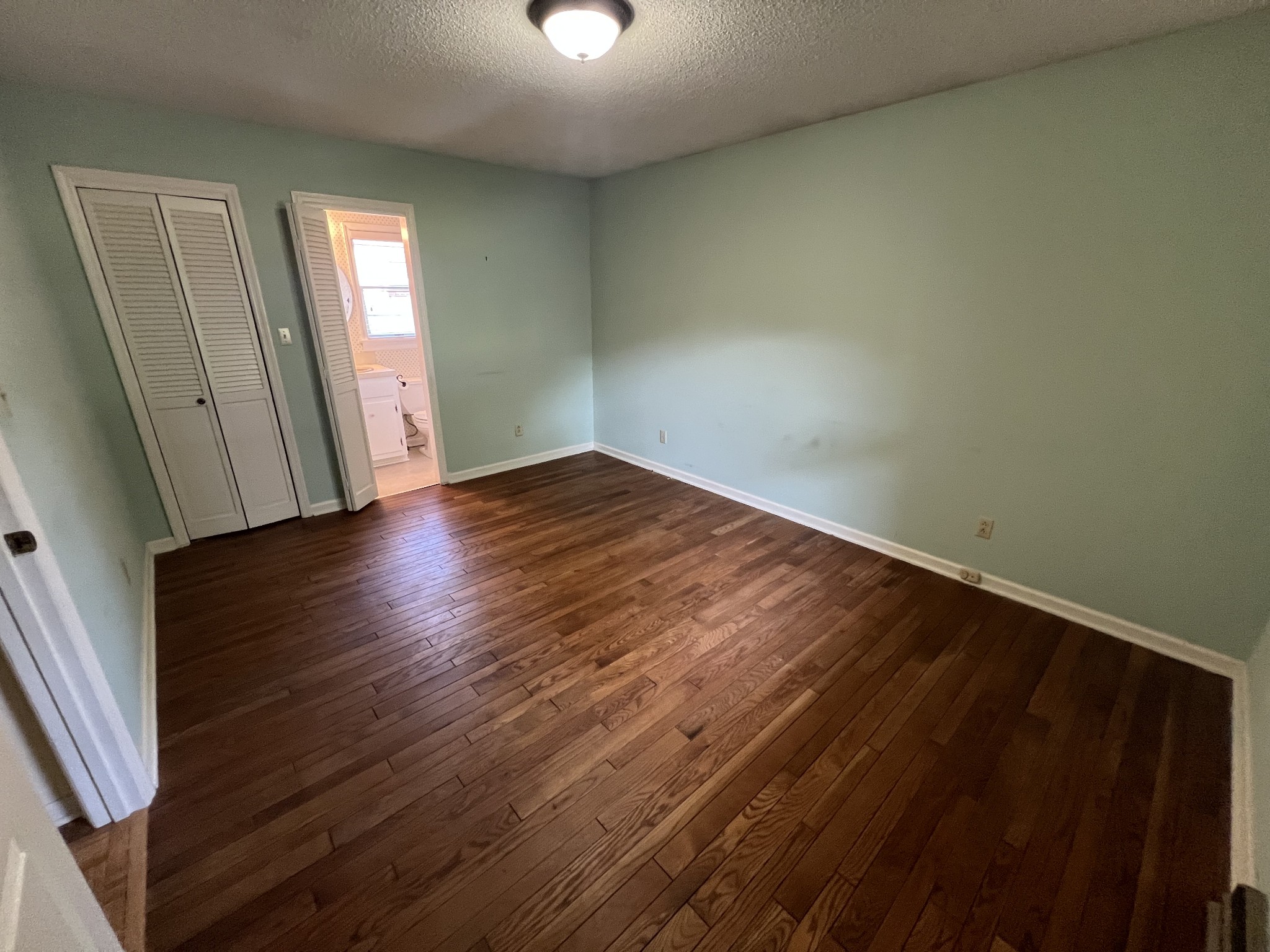 212 North 3rd Street Pulaski, TN 38478 - Photo 27 of 38 an empty room with wooden floor and windows