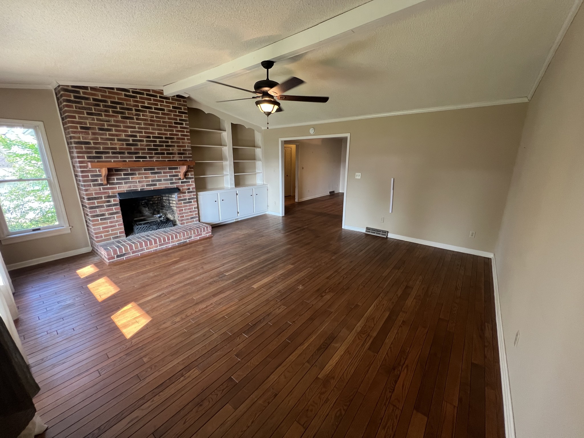 212 North 3rd Street Pulaski, TN 38478 - Photo 5 of 38 wooden floor in an empty room with a fireplace