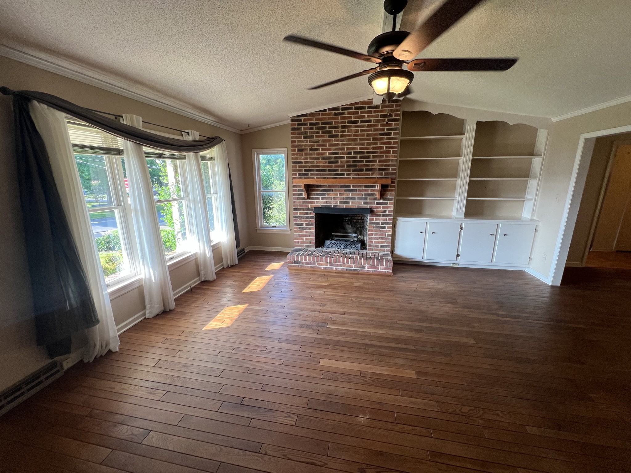 212 North 3rd Street Pulaski, TN 38478 - Photo 6 of 38 a view of a livingroom with wooden floor a fireplace and window