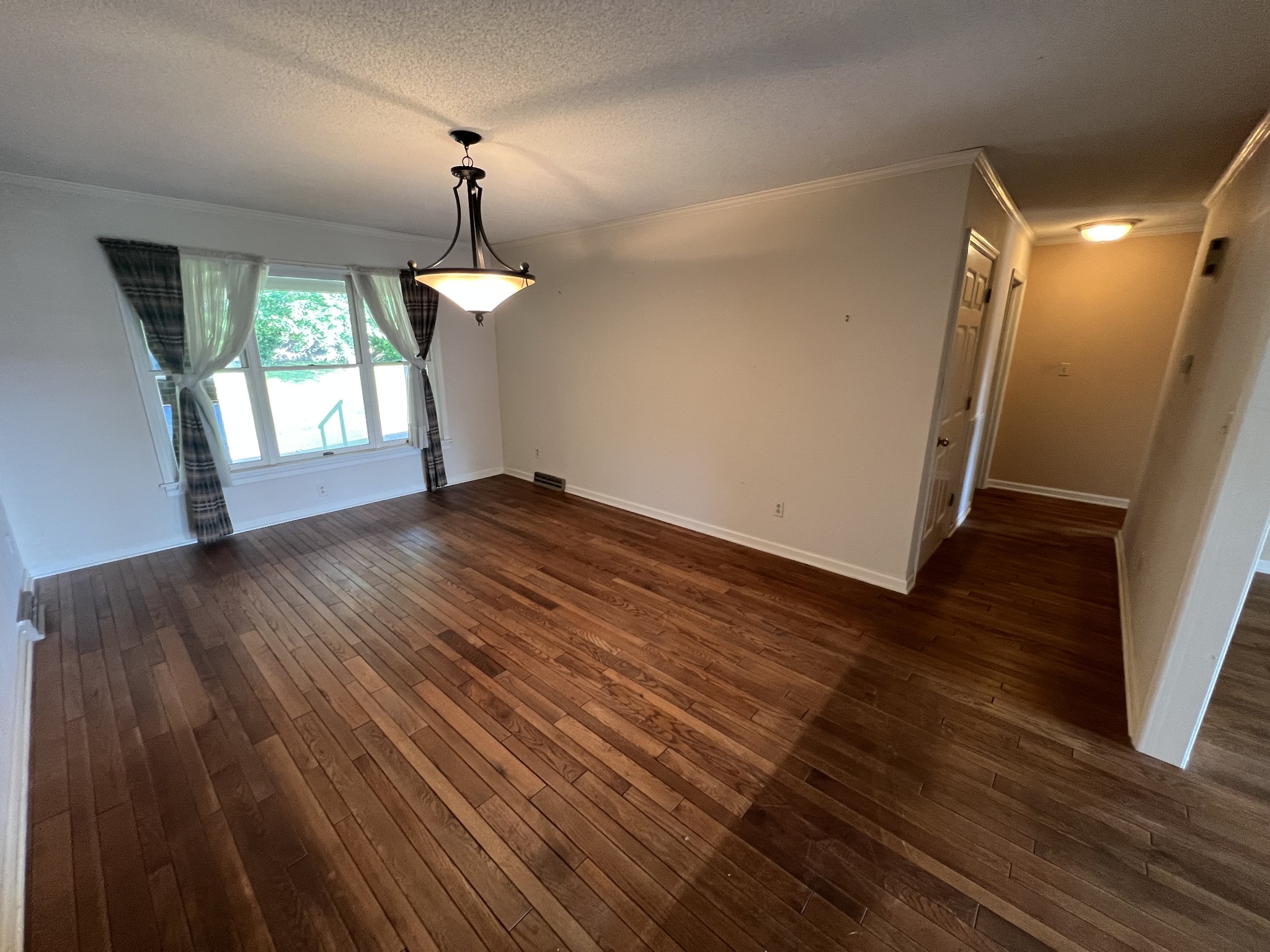 212 North 3rd Street Pulaski, TN 38478 - Photo 10 of 38 a view of empty room with wooden floor and fan