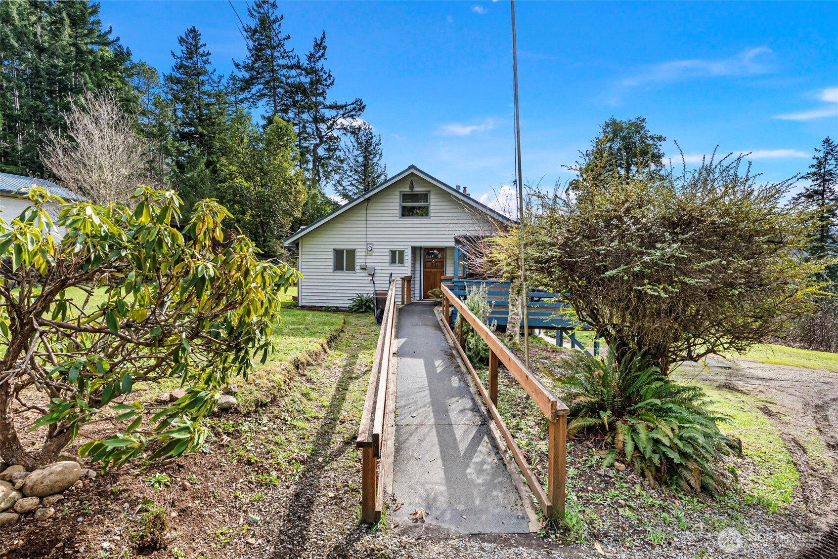 309723 Highway 101 Brinnon, WA 98320 - Photo 18 of 40 a view of a house with a yard