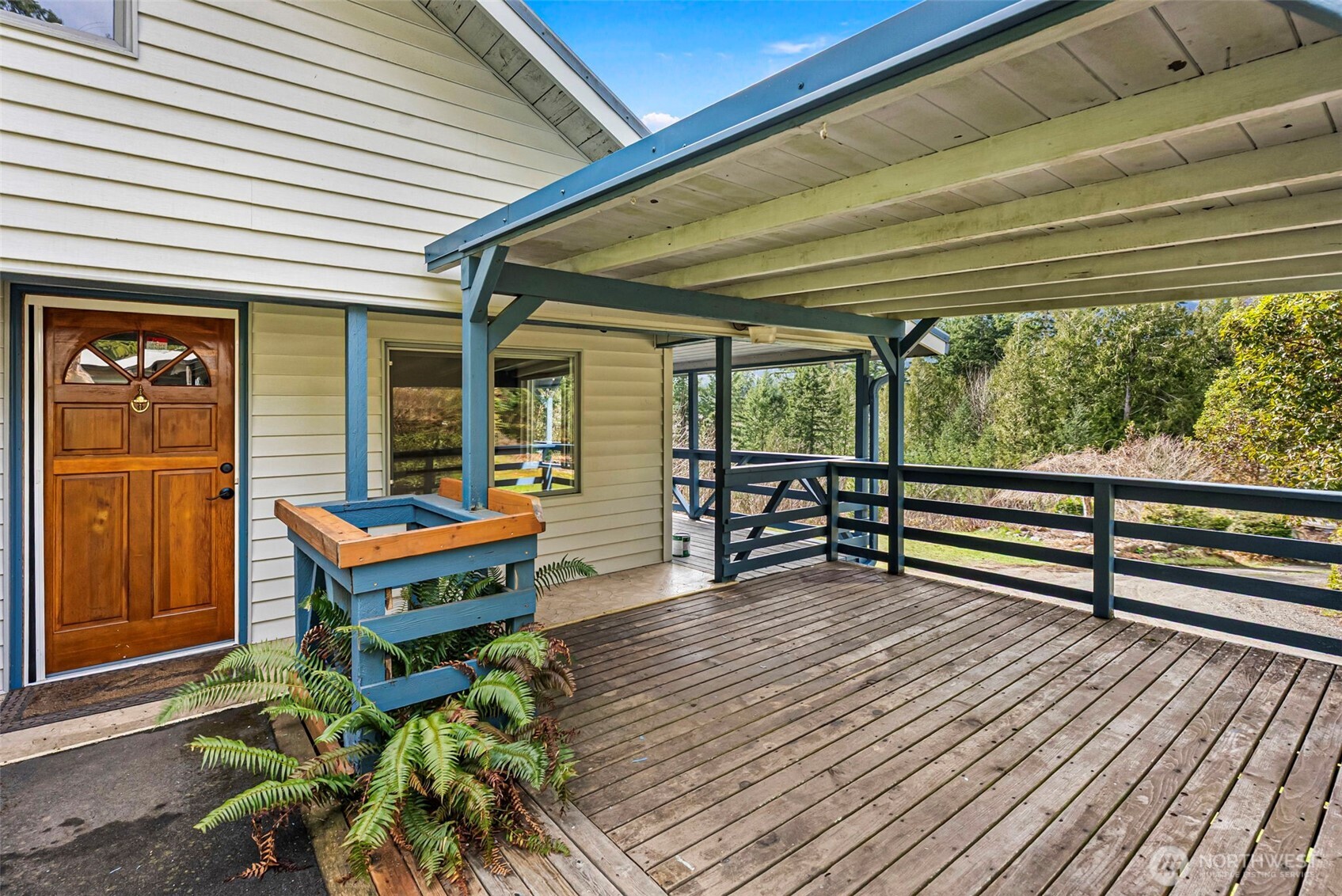 309723 Highway 101 Brinnon, WA 98320 - Photo 19 of 40 a balcony with furniture and a potted plant
