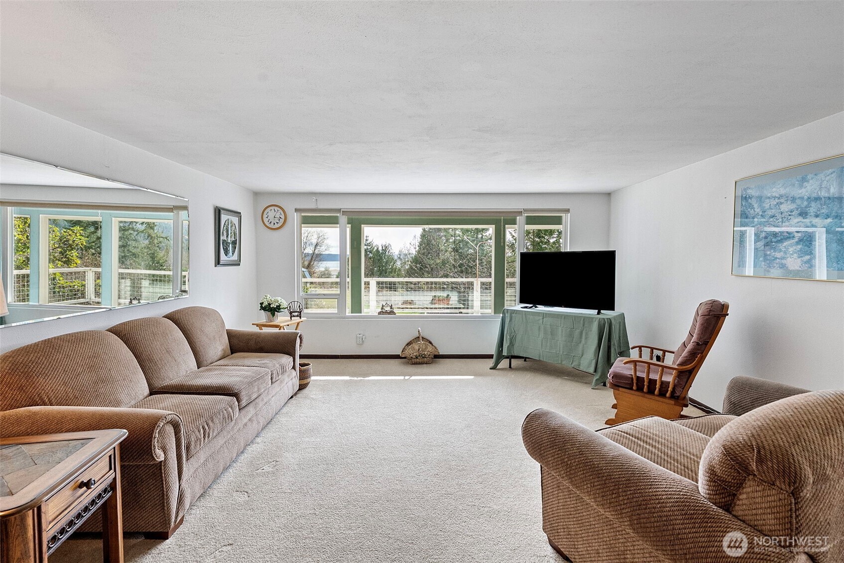 309723 Highway 101 Brinnon, WA 98320 - Photo 26 of 40 a living room with furniture a flat screen tv and a large window