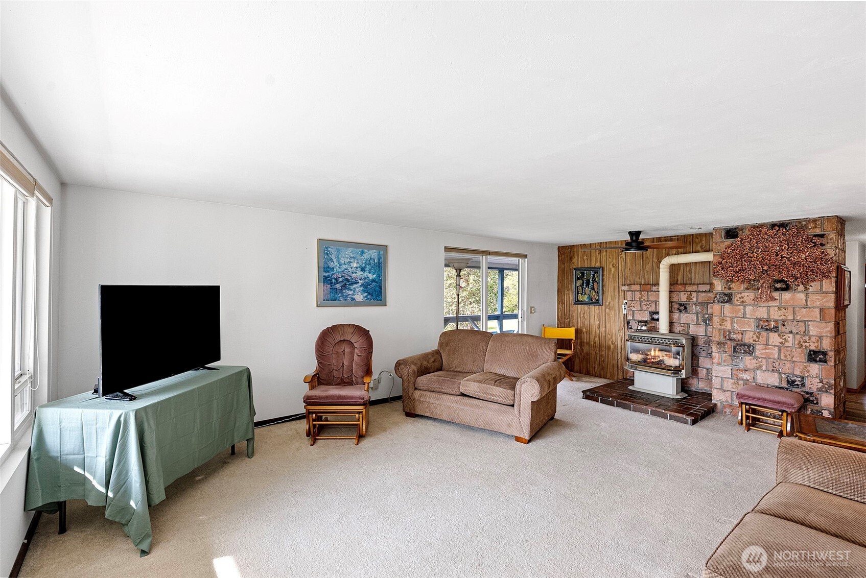 309723 Highway 101 Brinnon, WA 98320 - Photo 28 of 40 a living room with furniture and a flat screen tv