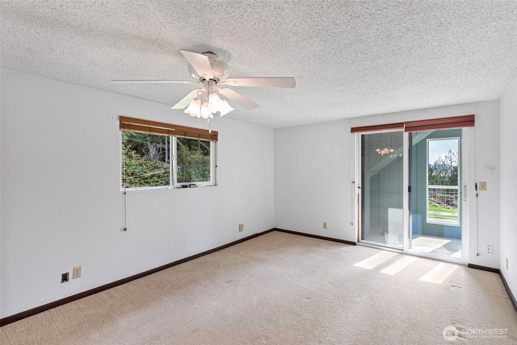 309723 Highway 101 Brinnon, WA 98320 - Photo 32 of 40 an empty room with a window and a ceiling fan