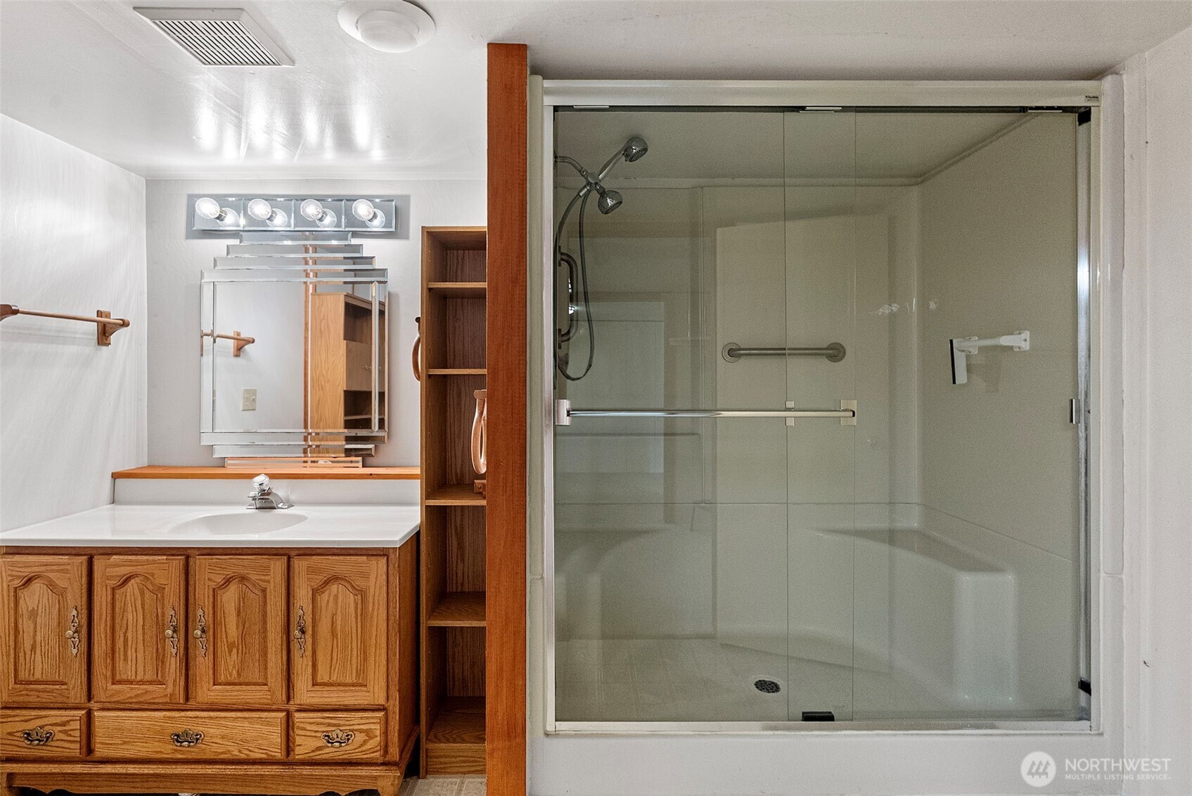 309723 Highway 101 Brinnon, WA 98320 - Photo 39 of 40 a bathroom with a shower a mirror and a sink