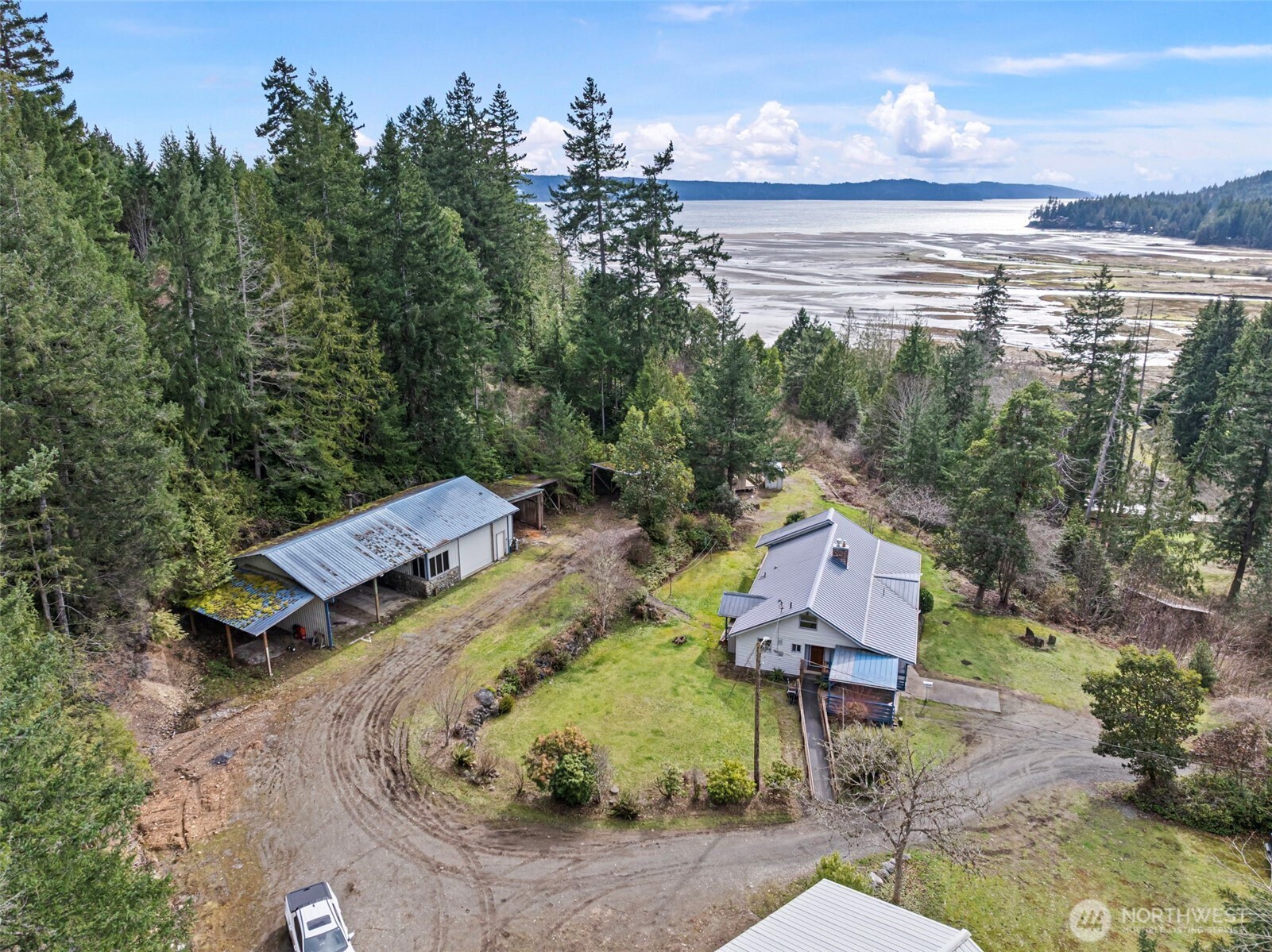 309723 Highway 101 Brinnon, WA 98320 - Photo 4 of 40 an aerial view of a house with a garden and lake view