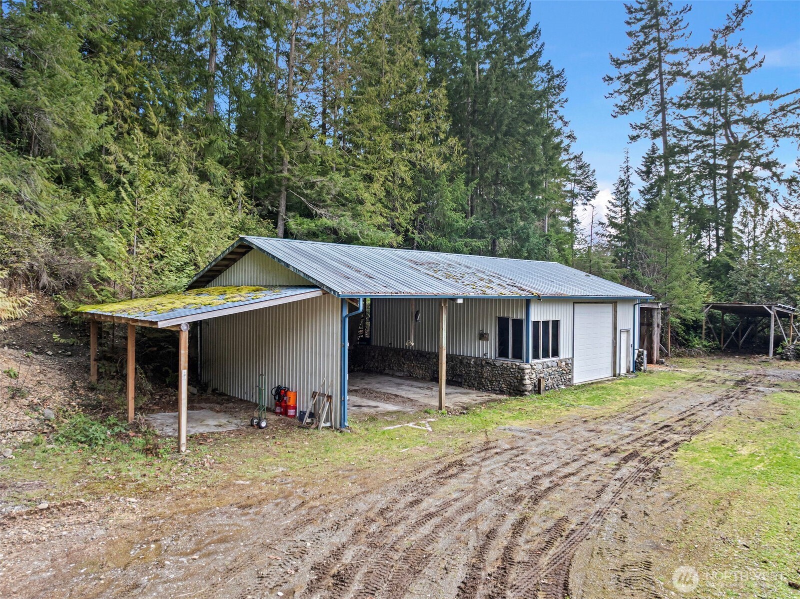 309723 Highway 101 Brinnon, WA 98320 - Photo 6 of 40 a house with trees in the background