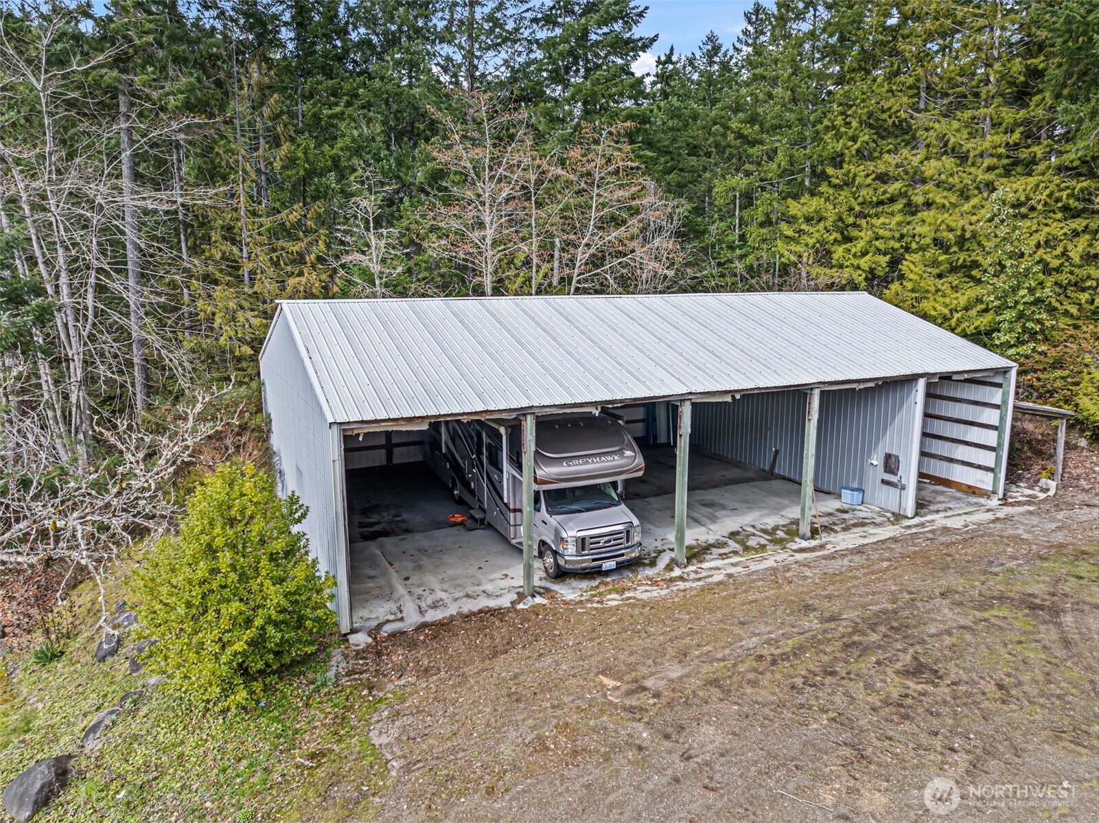 309723 Highway 101 Brinnon, WA 98320 - Photo 9 of 40 a view of a wooden house with a chairs and table in the patio