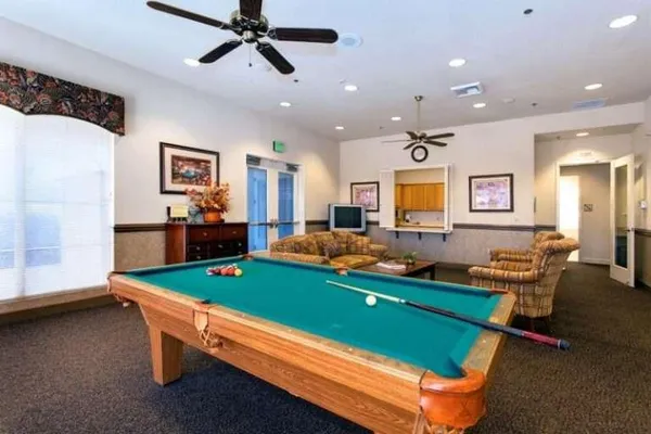 a room with pool table and windows