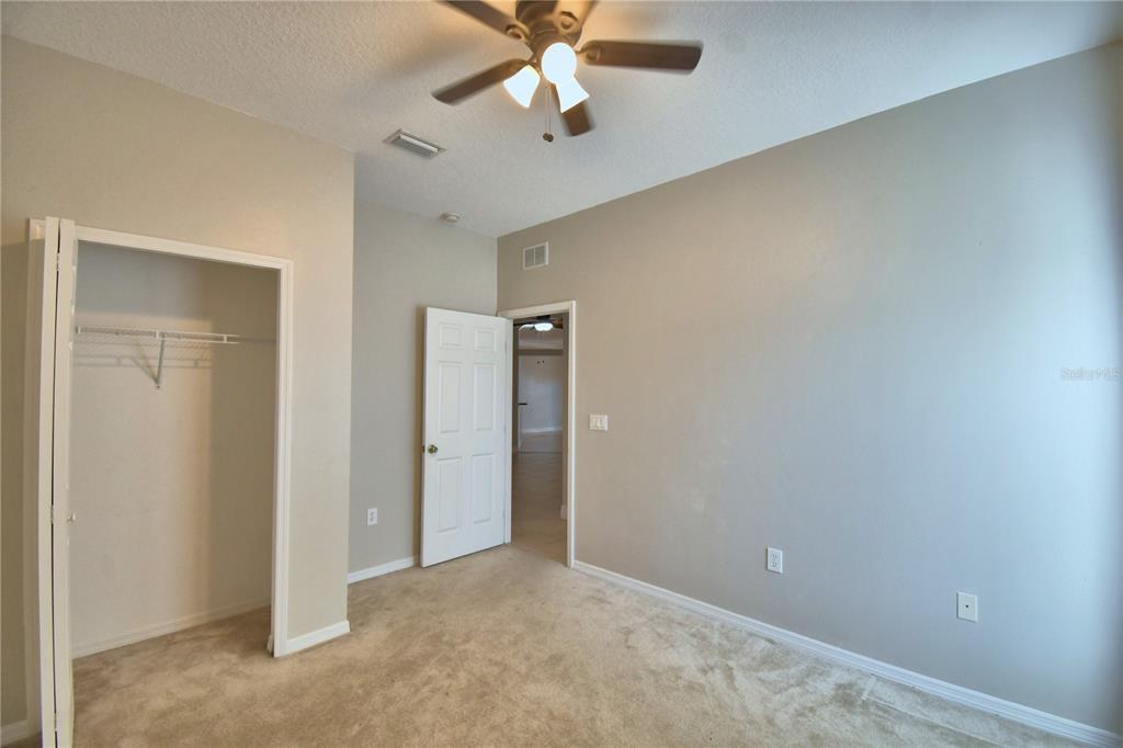 5610 Forest Ridge Drive Winter Haven, FL 33881 - Photo 14 of 70 an empty room with closet and a chandelier fan