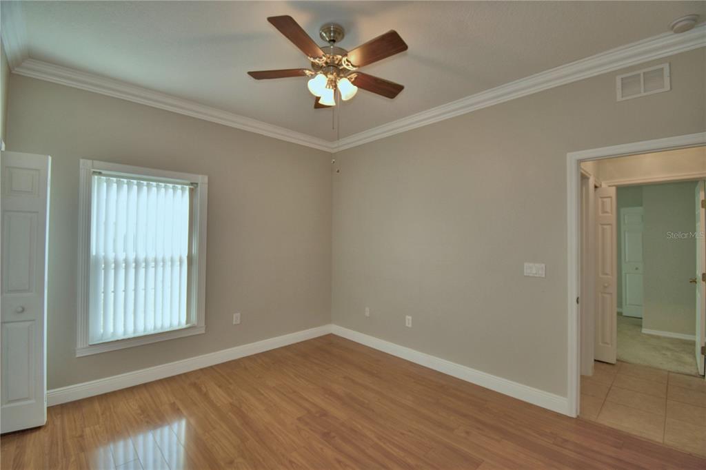 5610 Forest Ridge Drive Winter Haven, FL 33881 - Photo 17 of 70 an empty room with wooden floor and windows