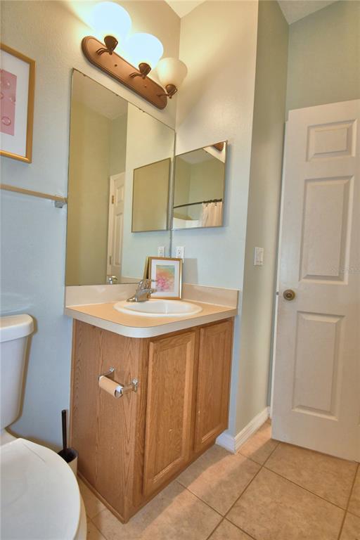 5610 Forest Ridge Drive Winter Haven, FL 33881 - Photo 33 of 70 a bathroom with a sink a toilet a mirror and shower
