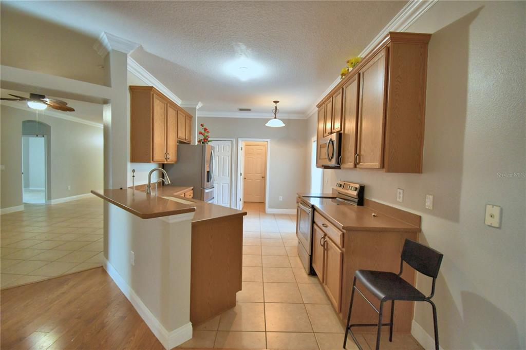 5610 Forest Ridge Drive Winter Haven, FL 33881 - Photo 34 of 70 a large kitchen with a sink and cabinets
