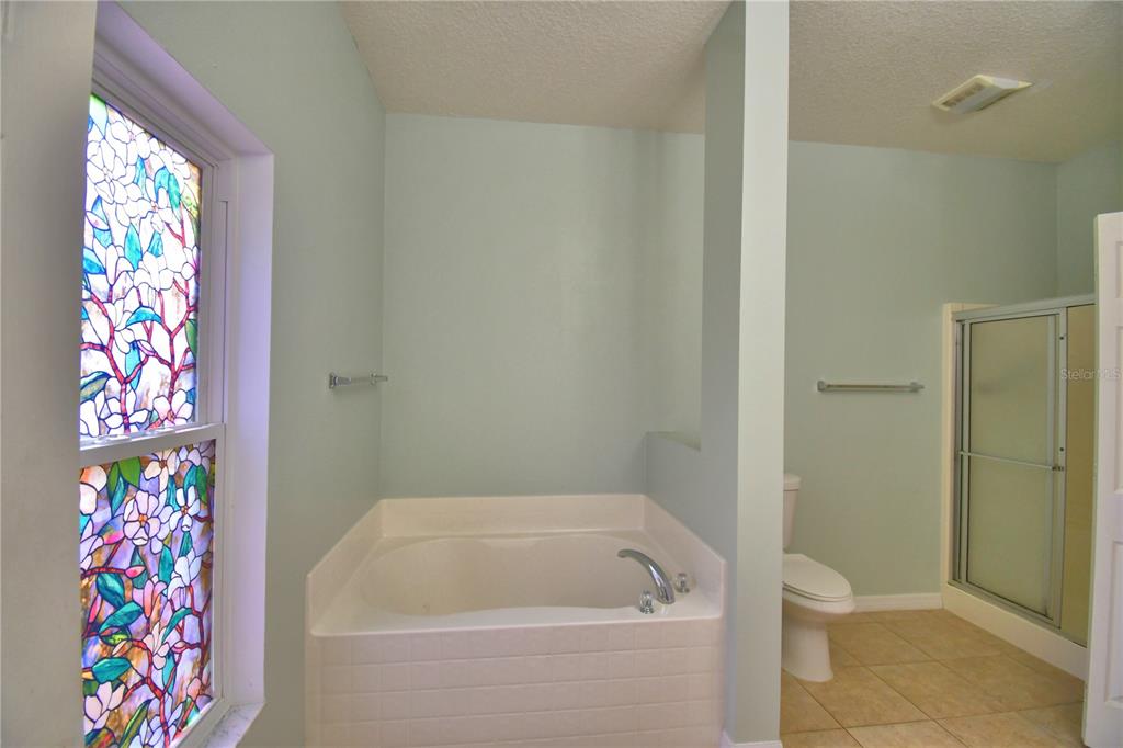 5610 Forest Ridge Drive Winter Haven, FL 33881 - Photo 37 of 70 a bathroom with a bathtub and shower