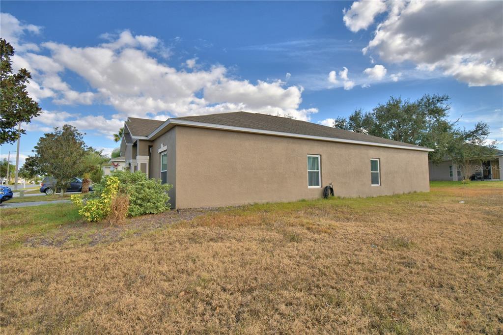 5610 Forest Ridge Drive Winter Haven, FL 33881 - Photo 51 of 70 a view of backyard of house and car parked