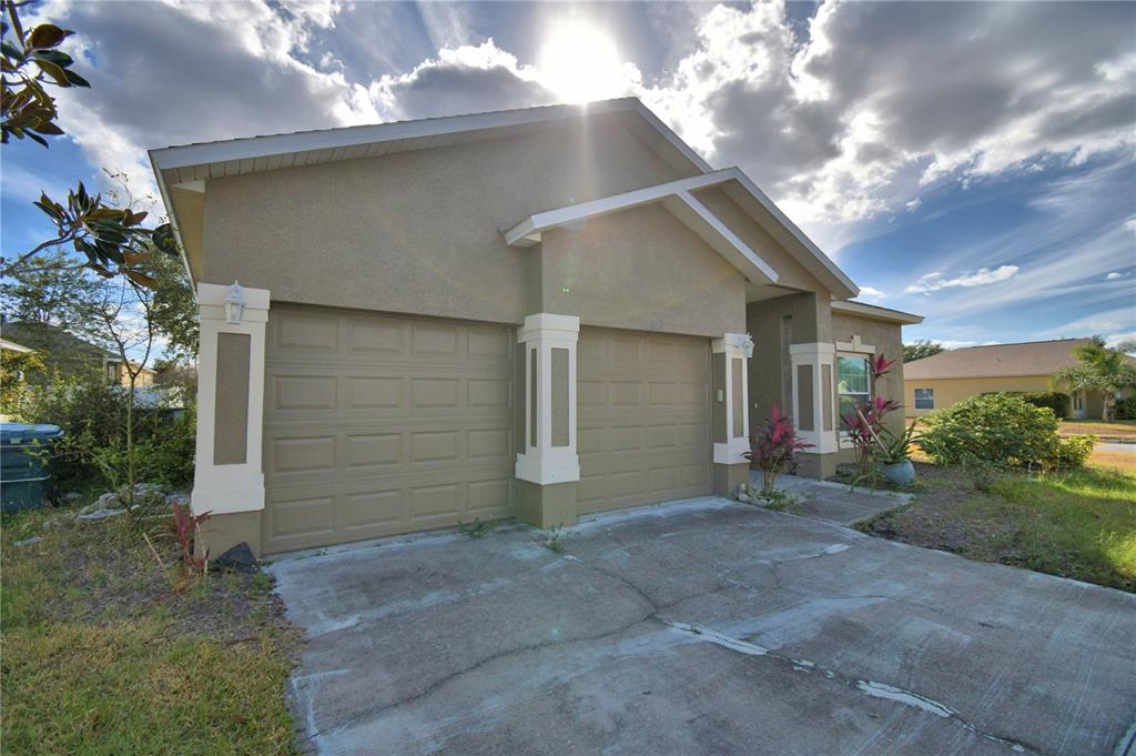 5610 Forest Ridge Drive Winter Haven, FL 33881 - Photo 52 of 70 a view of a house with a yard and garage
