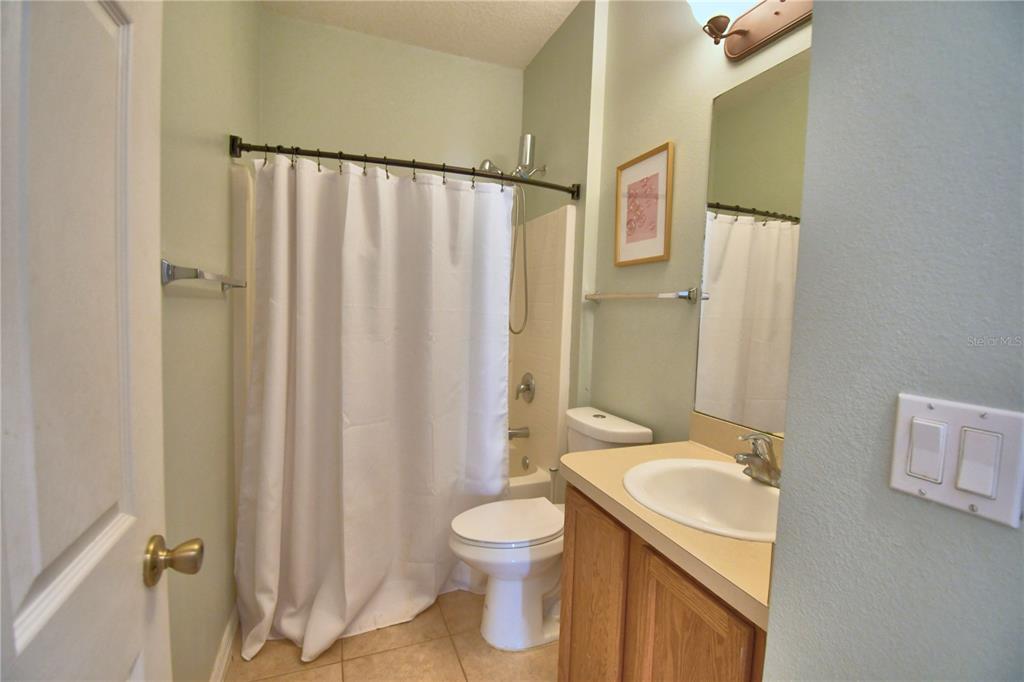 5610 Forest Ridge Drive Winter Haven, FL 33881 - Photo 55 of 70 a bathroom with a granite countertop sink toilet and shower