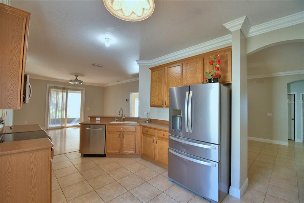 5610 Forest Ridge Drive Winter Haven, FL 33881 - Photo 56 of 70 a kitchen with stainless steel appliances granite countertop a refrigerator and a stove top oven