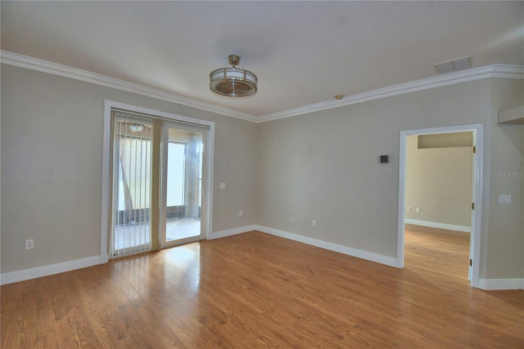 5610 Forest Ridge Drive Winter Haven, FL 33881 - Photo 59 of 70 a view of an empty room with wooden floor and a window