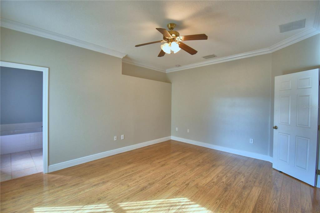 5610 Forest Ridge Drive Winter Haven, FL 33881 - Photo 60 of 70 a view of an empty room with wooden floor