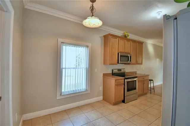 a view of an empty room and window and ceiling fan