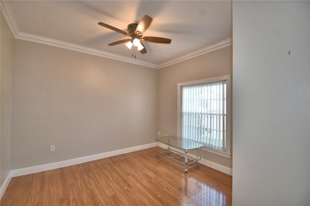 5610 Forest Ridge Drive Winter Haven, FL 33881 - Photo 61 of 70 an empty room with wooden floor fan and windows
