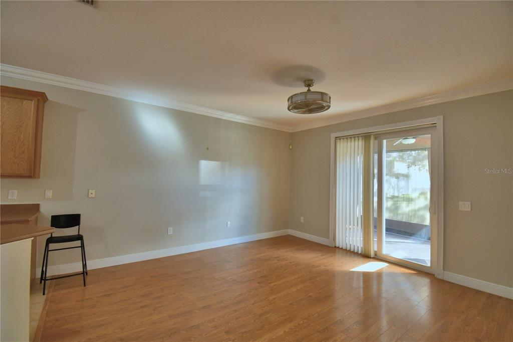 5610 Forest Ridge Drive Winter Haven, FL 33881 - Photo 63 of 70 a view of an empty room with window and wooden floor