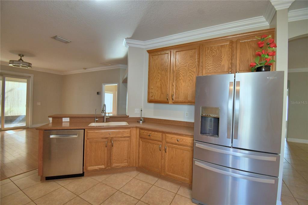 5610 Forest Ridge Drive Winter Haven, FL 33881 - Photo 7 of 70 a kitchen with stainless steel appliances granite countertop a refrigerator sink and cabinets