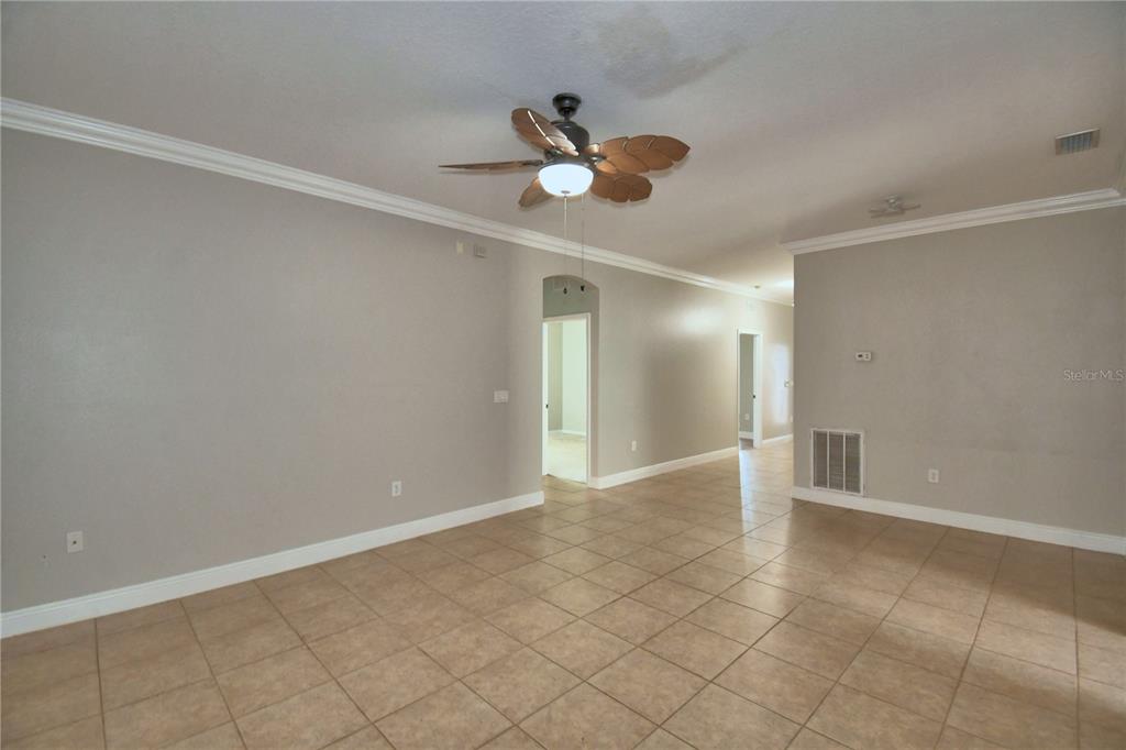 5610 Forest Ridge Drive Winter Haven, FL 33881 - Photo 10 of 70 a view of an empty room and window and ceiling fan