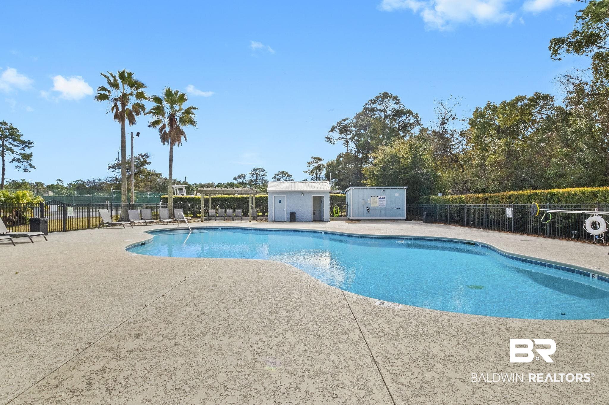 25861 Canal Road, Unit 78 Orange Beach, AL 36561 - Photo 33 of 45 Community pool with a patio and fence