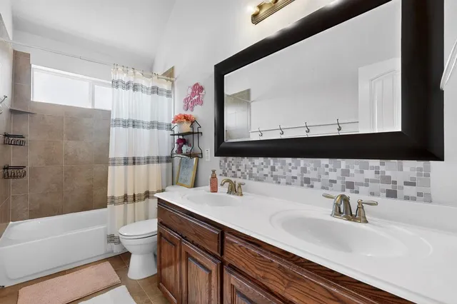 a kitchen with stainless steel appliances granite countertop a sink a stove and a wooden floors