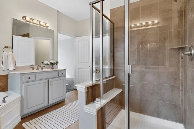 a bathroom with a bathtub a sink and a mirror