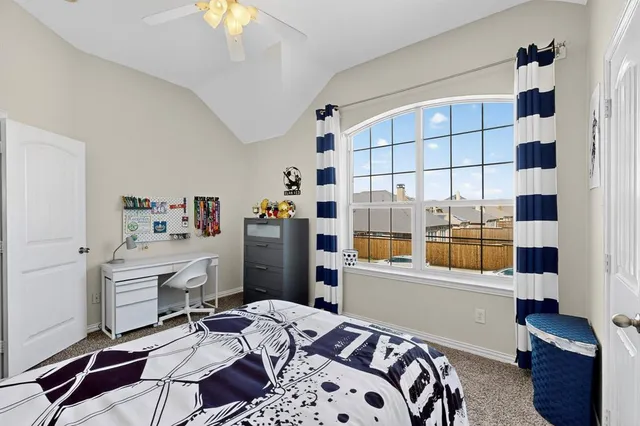 a bedroom with bed and a chandelier