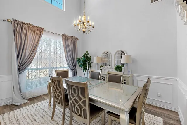 a dining room with furniture a rug and a chandelier
