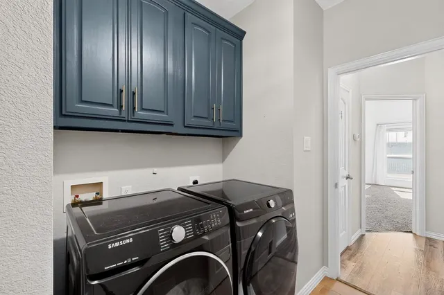 a living room with furniture a flat screen tv and a window