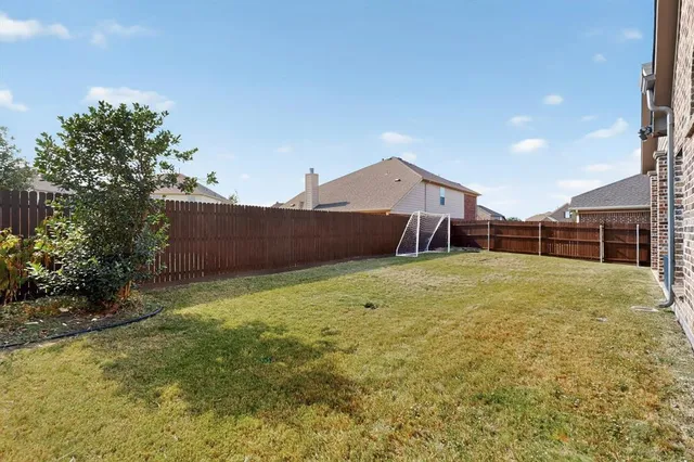 a building outdoor space with patio furniture and garden