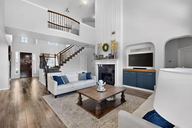 a living room with furniture and a fireplace