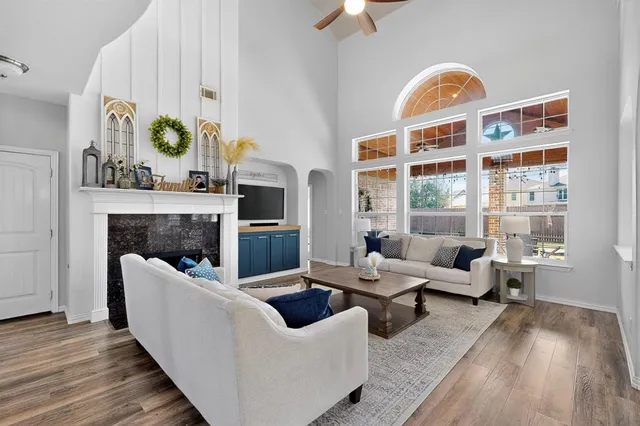 a living room with fireplace furniture and a window