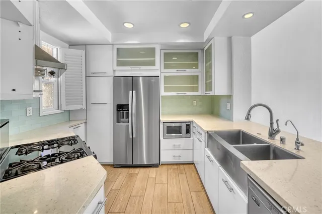 a kitchen with a sink stove and cabinets