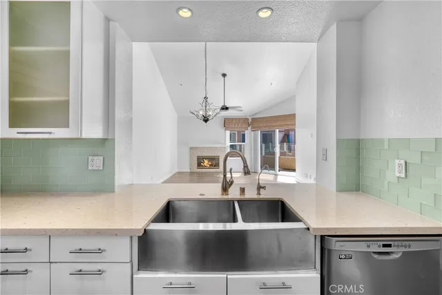 a view of an empty room with window and bathroom