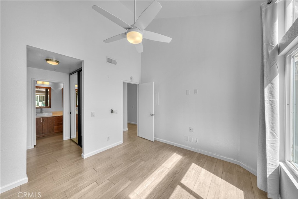 2000 Highway 1, Unit 309 Huntington Beach, CA 92648 - Photo 22 of 33 an empty room with wooden floor and windows