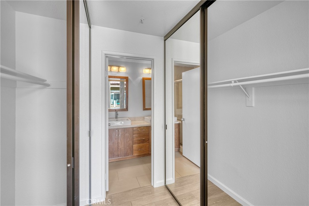 2000 Highway 1, Unit 309 Huntington Beach, CA 92648 - Photo 24 of 33 a bathroom with a glass shower door and a mirror