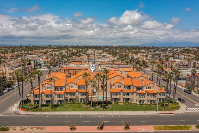 an aerial view of residential houses with a city street