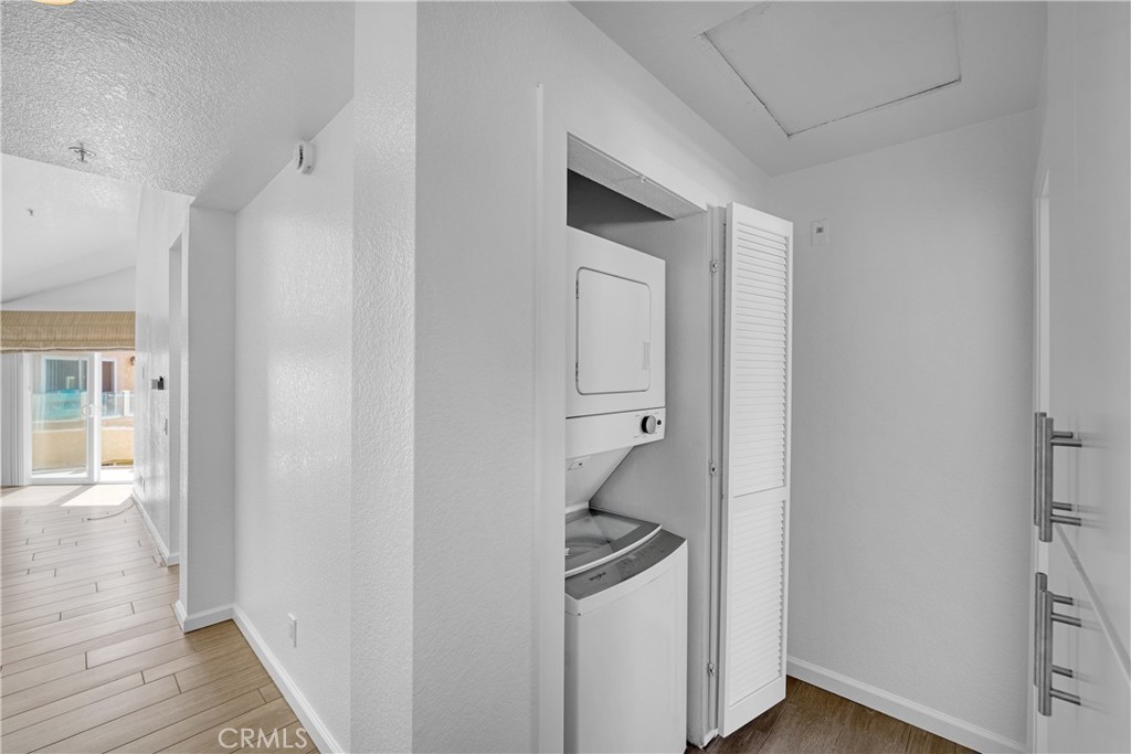 2000 Highway 1, Unit 309 Huntington Beach, CA 92648 - Photo 31 of 33 a room with wooden floor and white walls