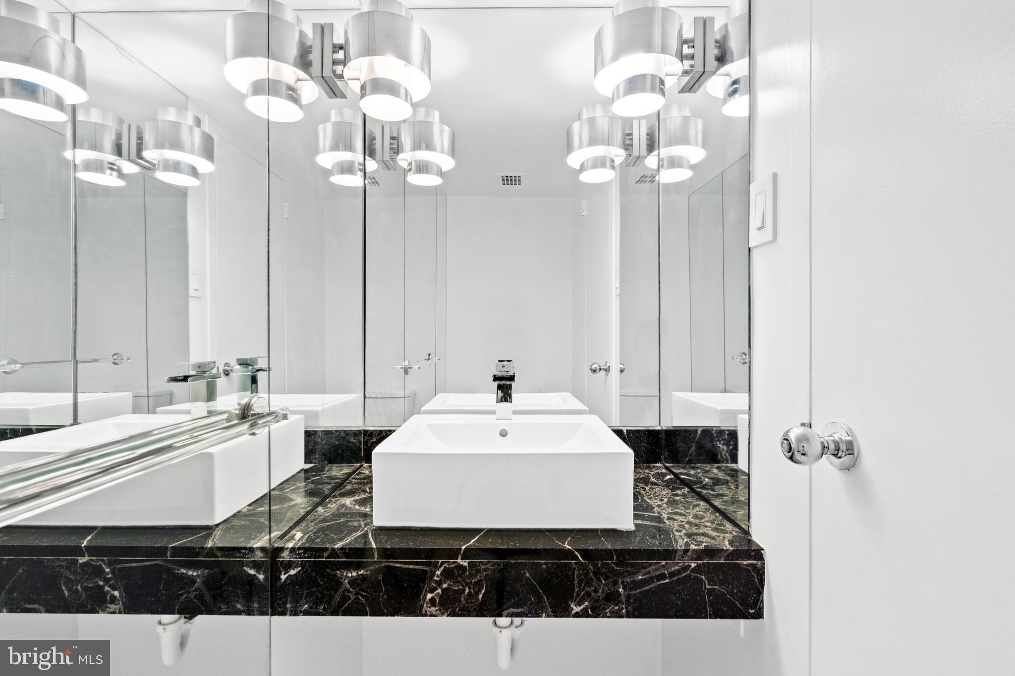 2510 Virginia Avenue Northwest, Unit 708N Washington, DC 20037 - Photo 12 of 37 a bathroom with a sink vanity and a mirror