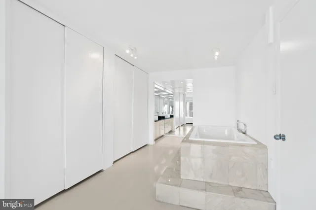 a en suite bathroom with a sink and a large mirror