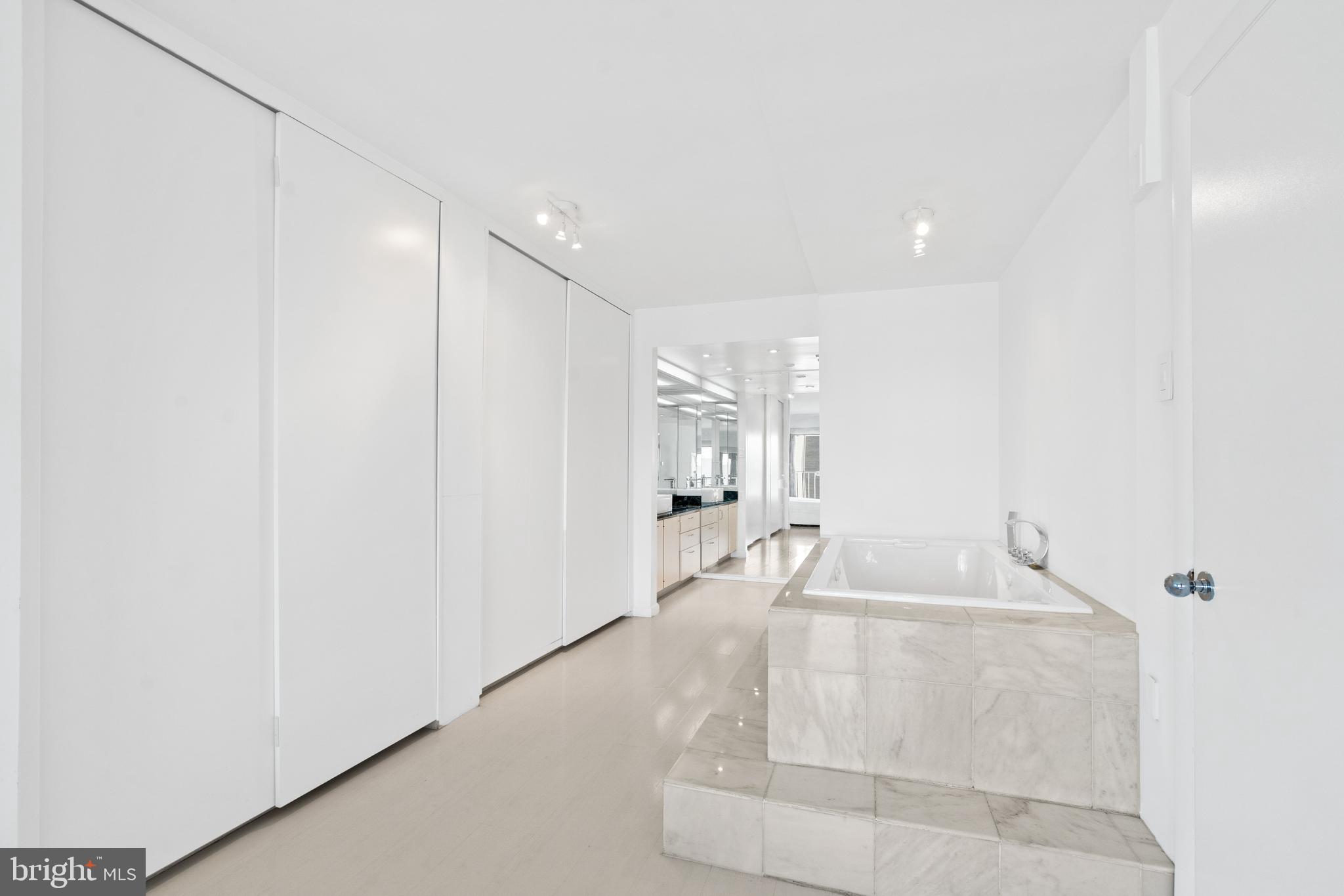 2510 Virginia Avenue Northwest, Unit 708N Washington, DC 20037 - Photo 17 of 37 a en suite bathroom with a sink and a large mirror