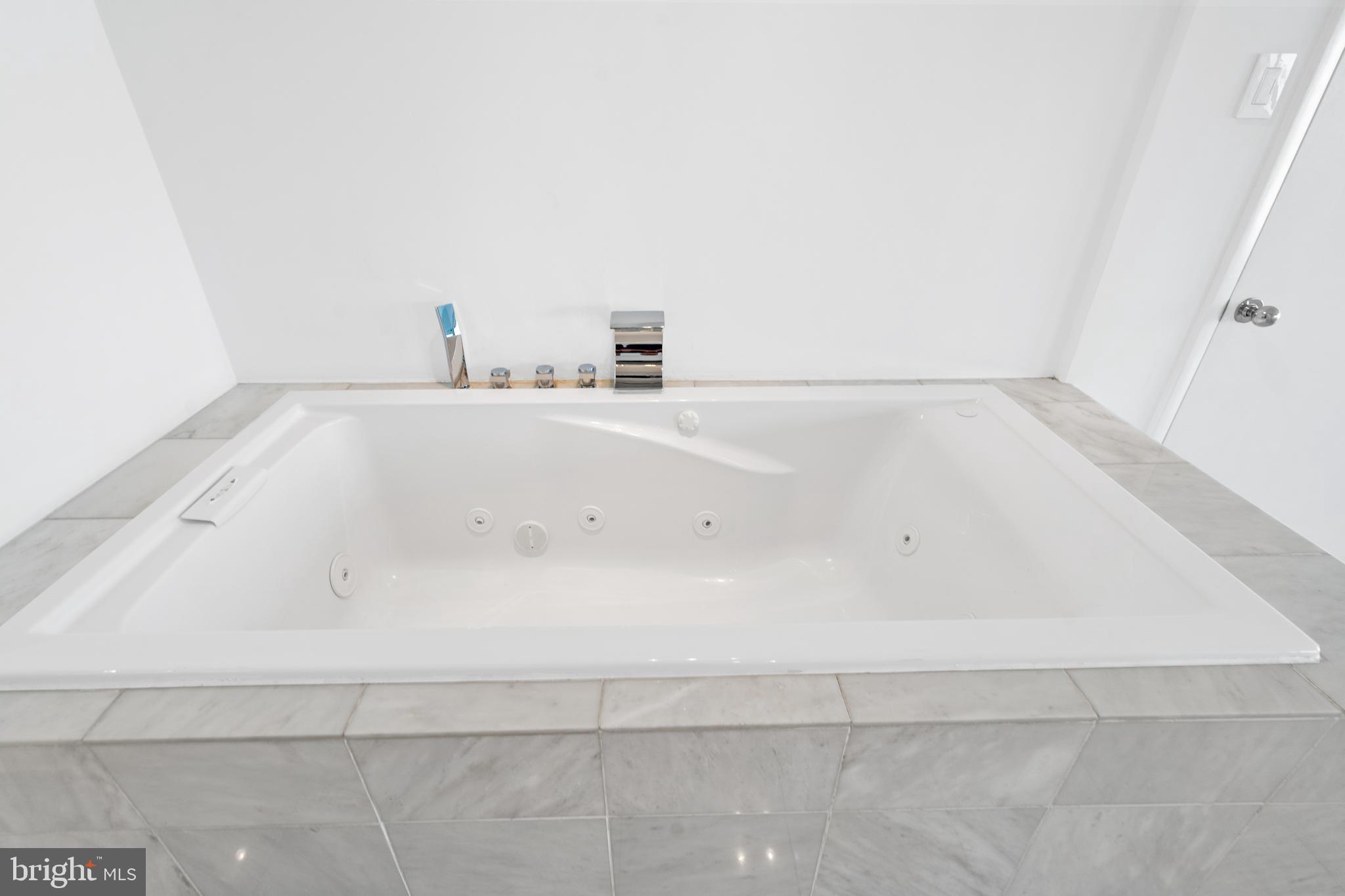 2510 Virginia Avenue Northwest, Unit 708N Washington, DC 20037 - Photo 20 of 37 a view of a bathtub in a bathroom