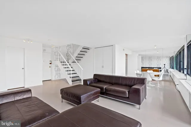 a living room with furniture and a book shelf